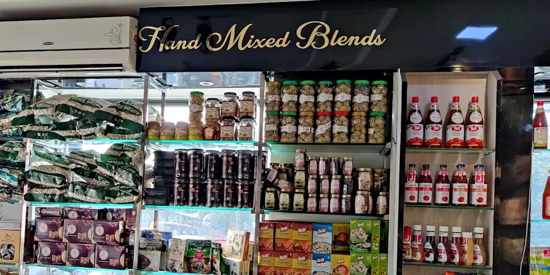 The Hand Mixed Blends counter, its name in gold script on a black board above rows of glass jars